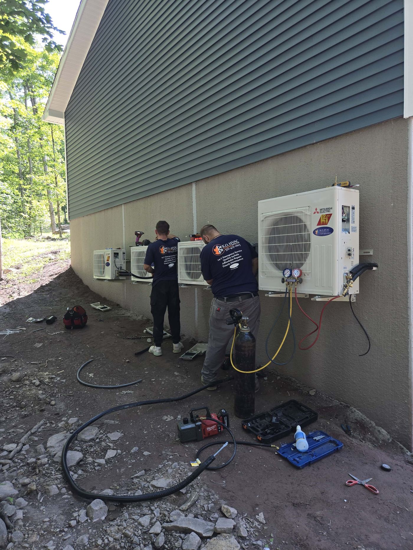 K.O. HVAC team installing a line of wall mounted Mitsubishi Electric high efficiency condensers.