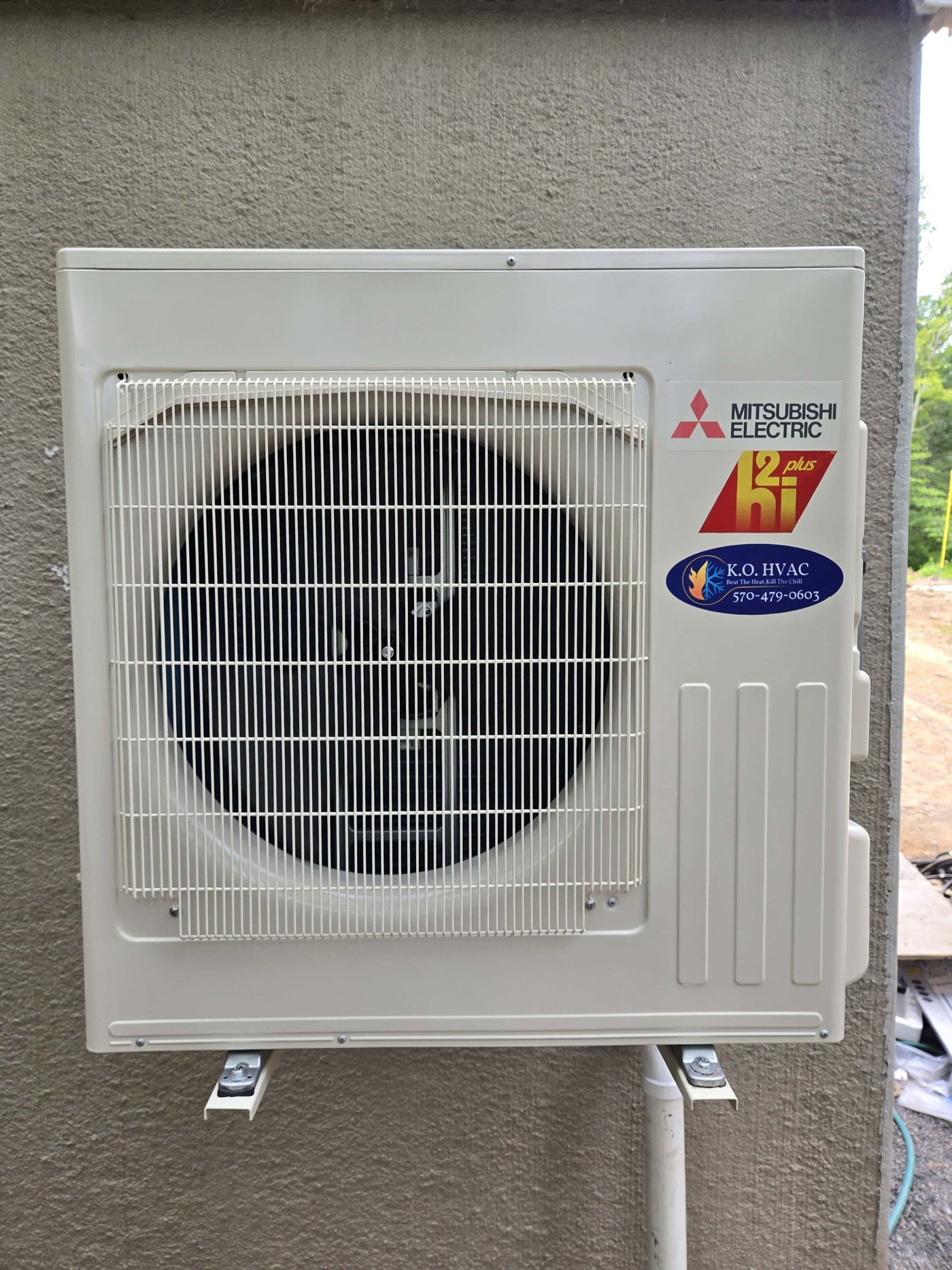 Mitsubishi Ductless high efficiency condenser mounted on an exterior wall.