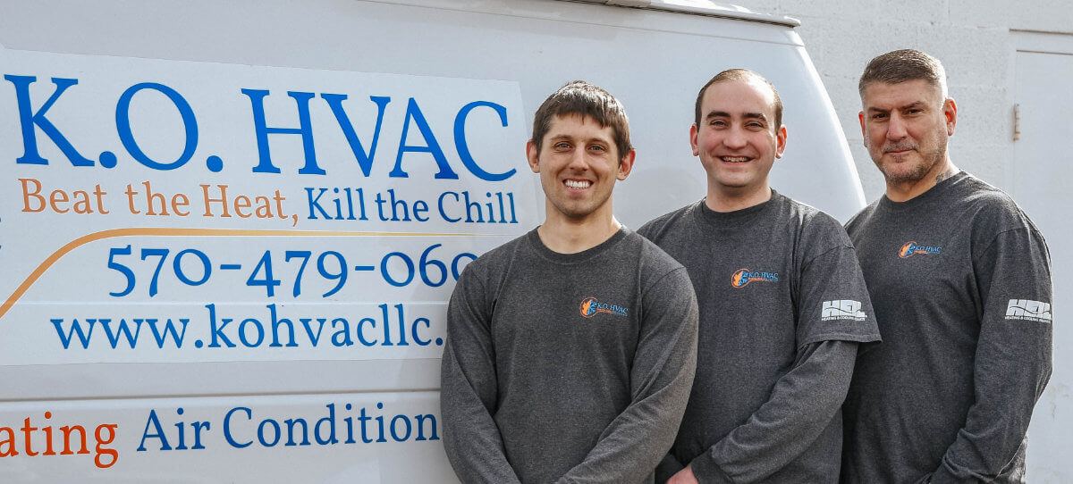 KO HVAC owners standing in front of company service vehicle in Kingston, PA.