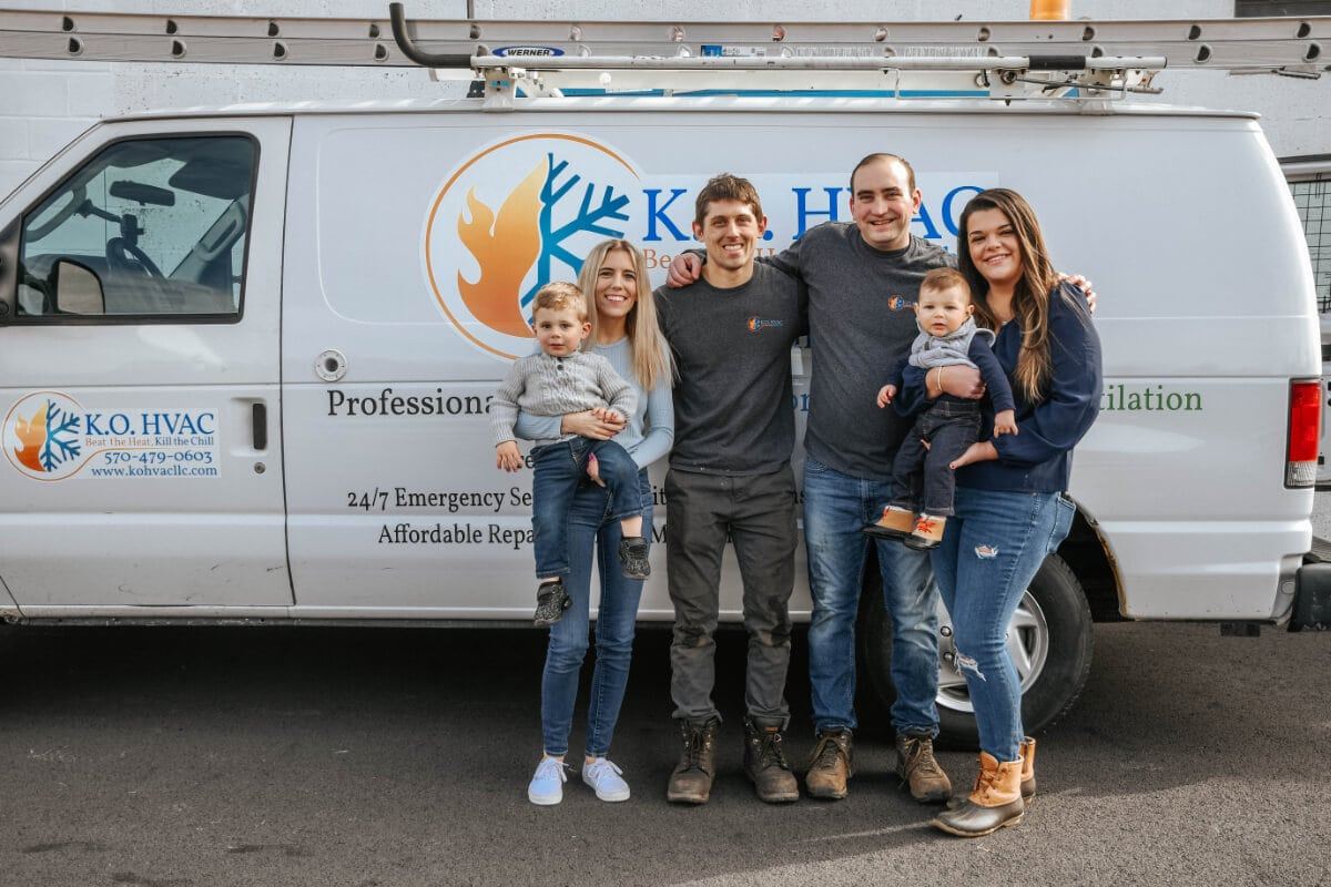 KO HVAC owners with their wives and children in front of service vehicle at local Kingston, PA, office.