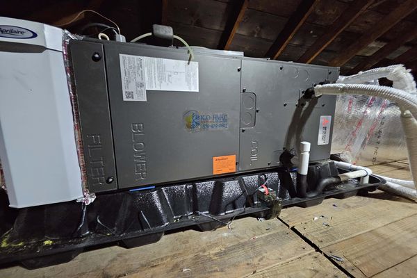 An attic air handler with the KO HVAC label on its cabinet