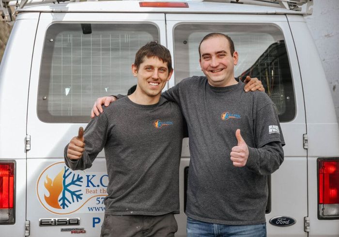 KO HVAC co-owners Stephen Klebetz and Cody Orr giving a thumbs-up beside the company's first van