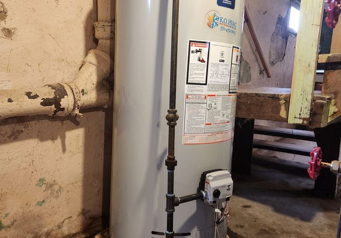 A gas water heater with a KO HVAC sticker