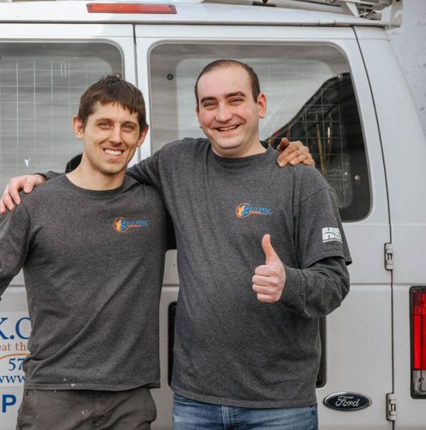 KO HVAC co-owners Stephen Klebetz and Cody Orr giving a thumbs-up beside the company's first van