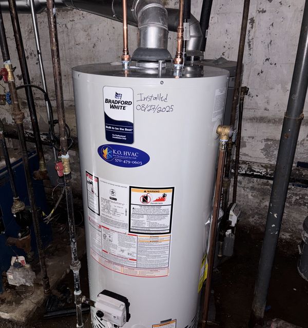 Bradford White water heater with a KO HVAC sticker, installed in a basement