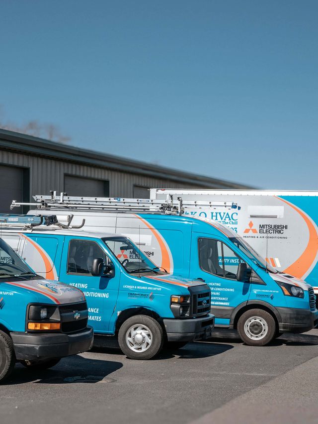 Wrapped KO HVAC vans and the box truck lined up outside the Page Avenue shop
